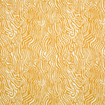 Detail of fabric in a playful animal print in light orange on a white field.