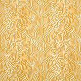 Detail of fabric in a playful animal print in light orange on a white field.