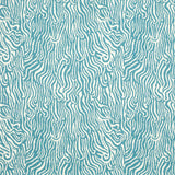 Detail of fabric in a playful animal print in blue on a white field.