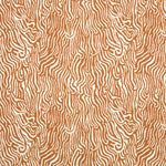 Detail of fabric in a playful animal print in burnt orange on a white field.