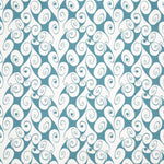 Detail of fabric in a playful abstract shape print in white on a turquoise field.