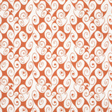 Detail of fabric in a playful abstract shape print in white on a burnt orange field.