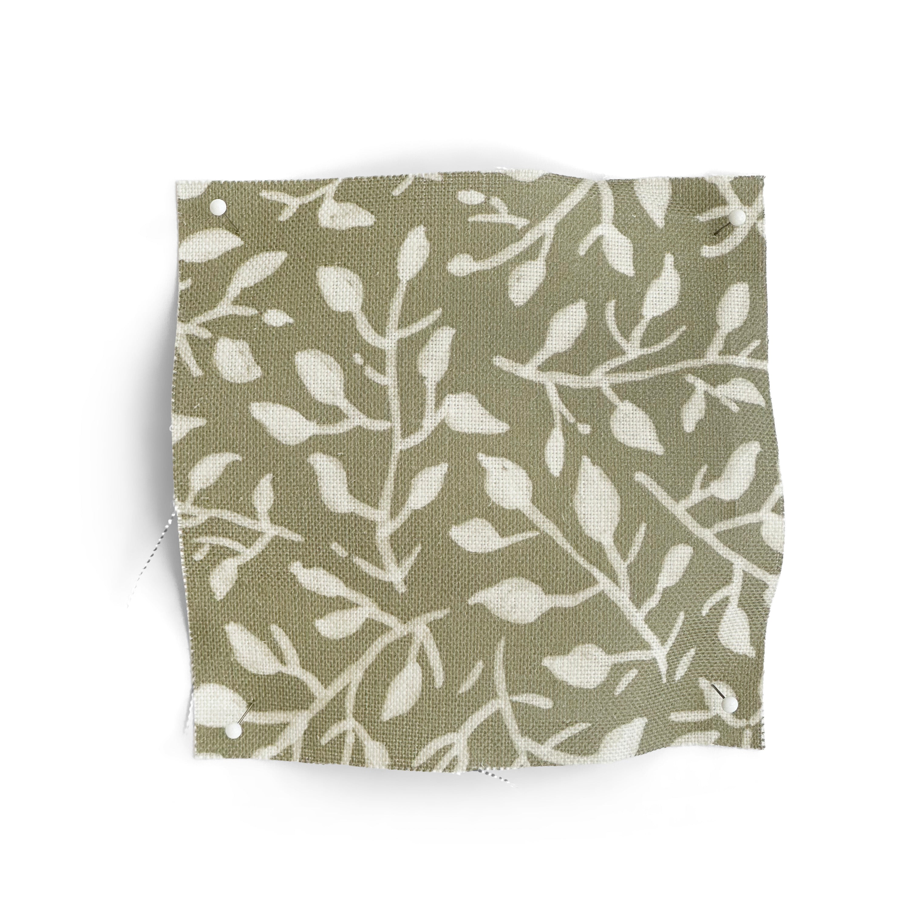 Fabric swatch with white leaf pattern on a green background