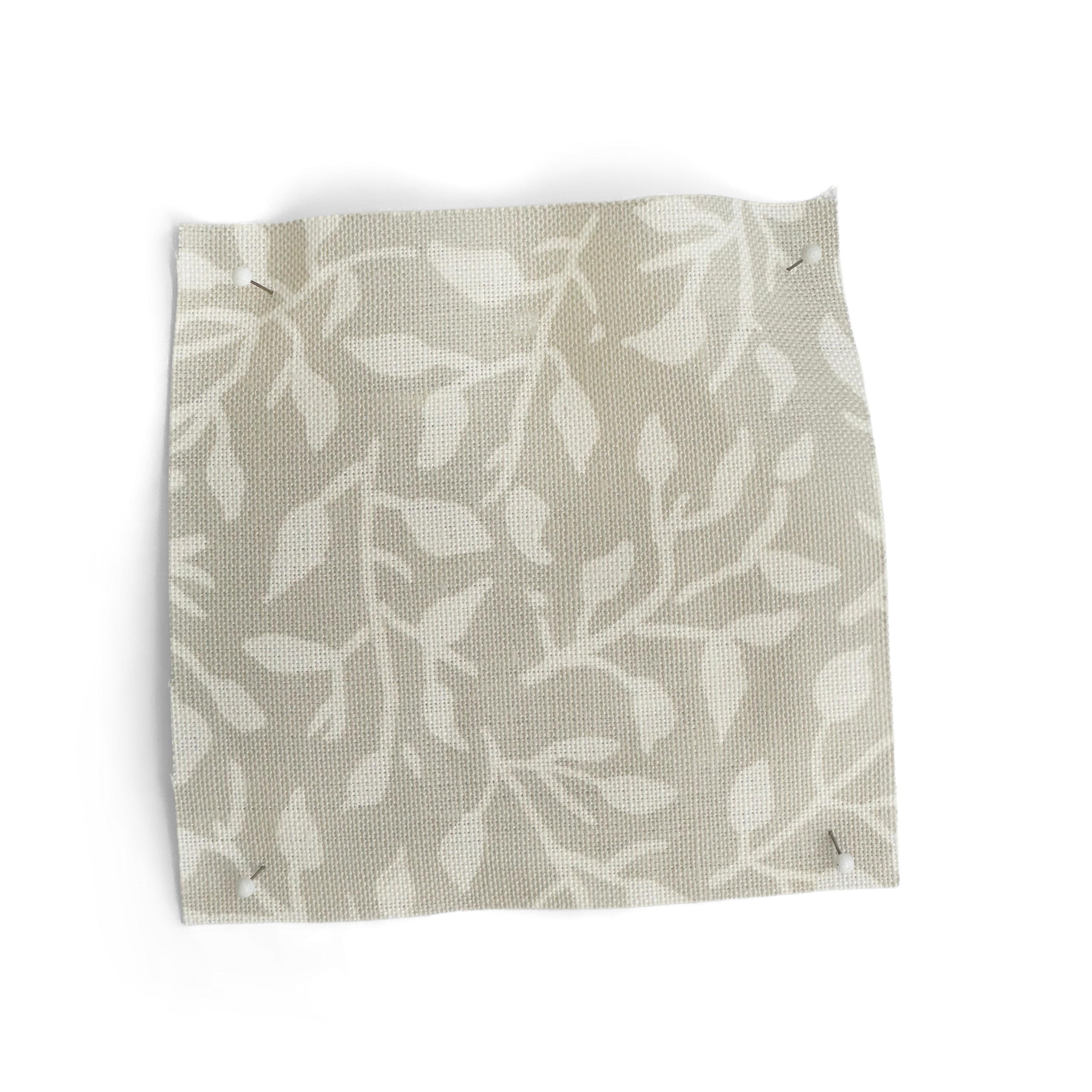 Fabric swatch with leaf pattern in pale grey on a white background