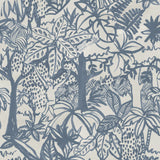 Detail of wallpaper in a playful jungle print in blue on a cream field.