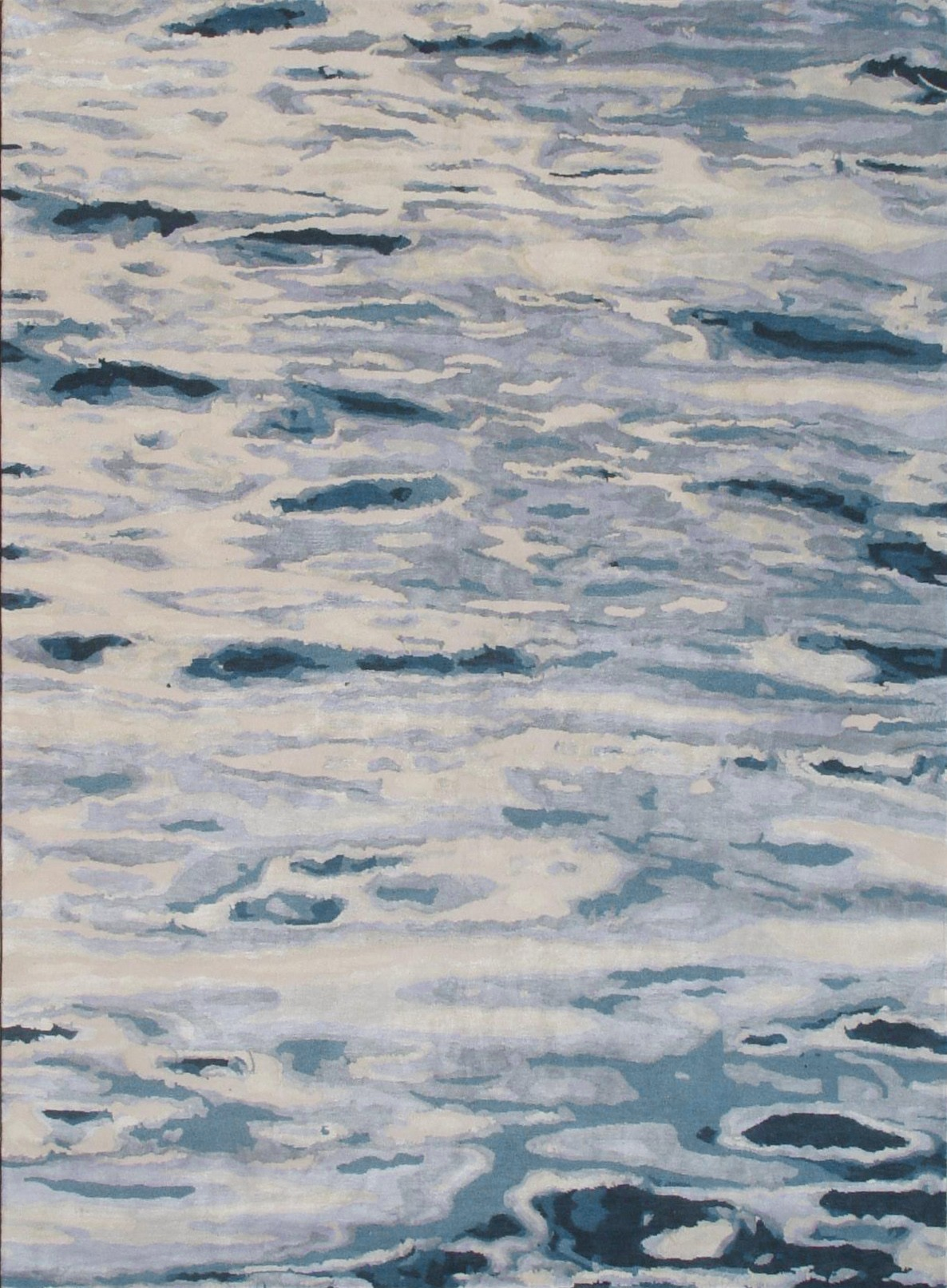 Handknotted rug in an abstract watercolor design in shades of blue, grey and cream.