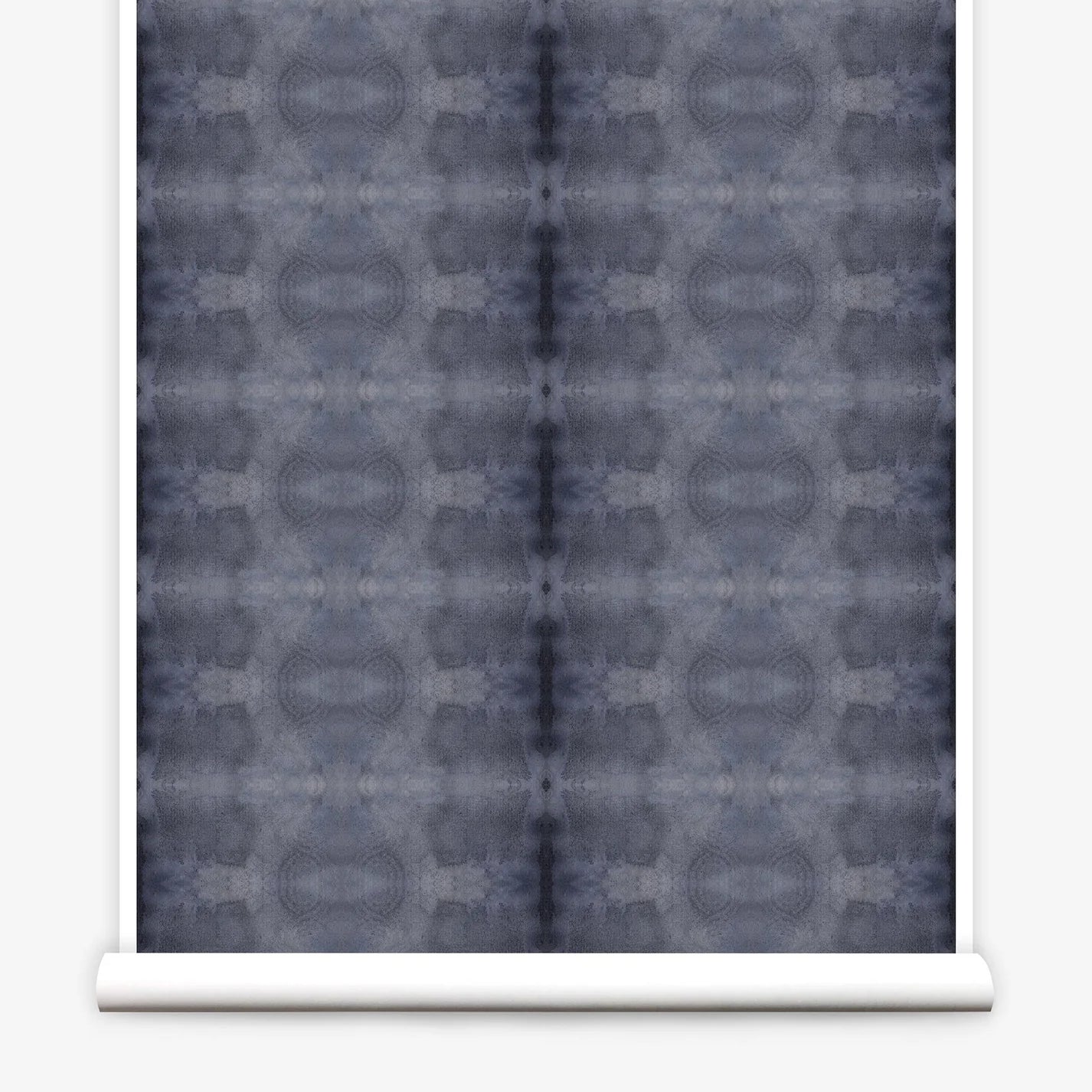 Partially unrolled wallpaper yardage in a repeating ink blot print in navy on a charcoal field.