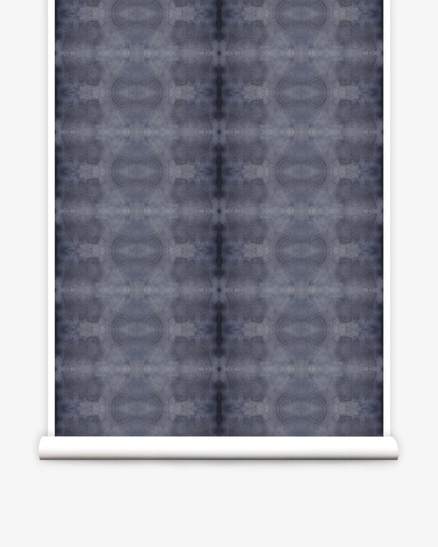 Partially unrolled wallpaper yardage in a repeating ink blot print in navy on a charcoal field.