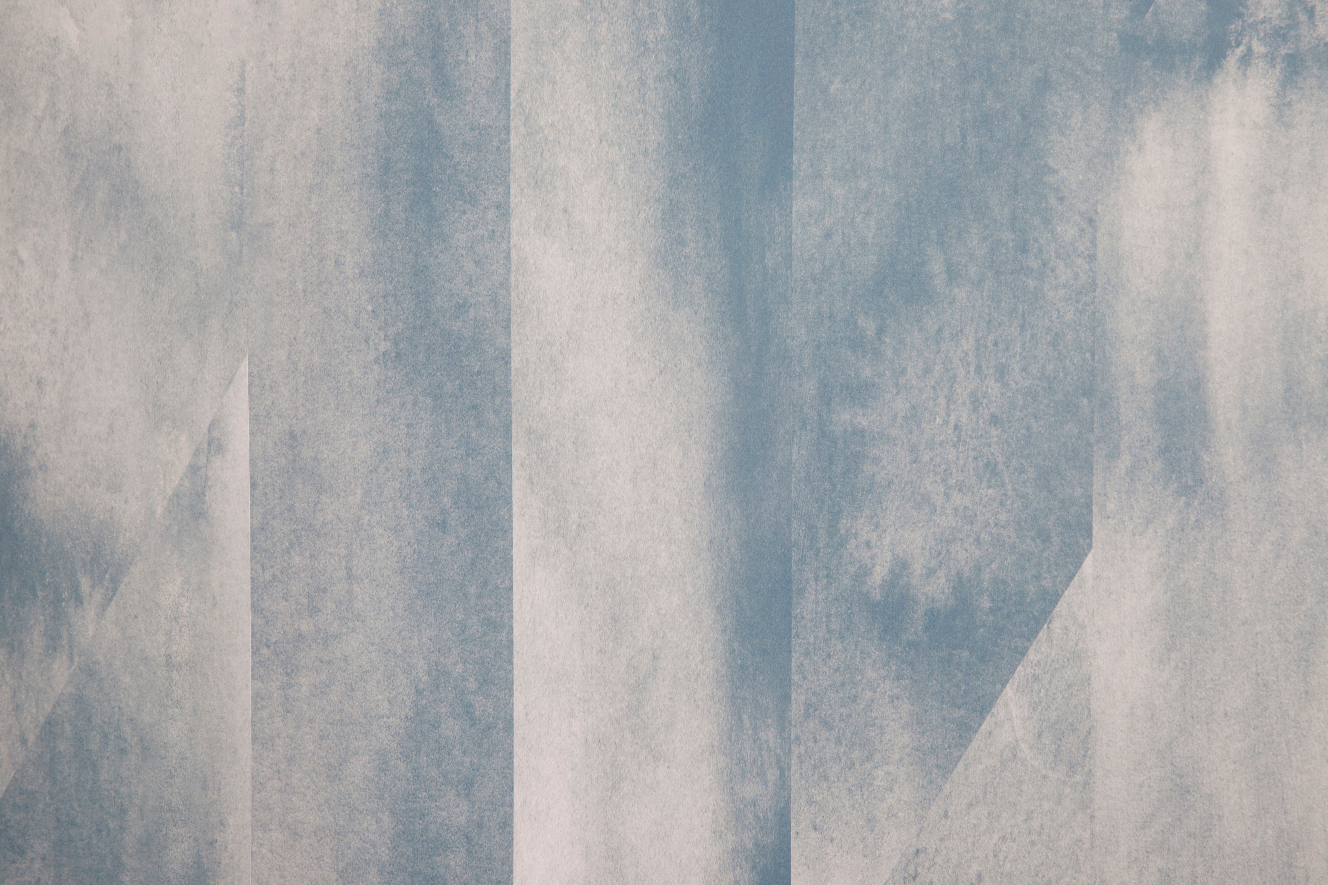 Detail of wallpaper in a linear geometric print in shades of blue and gray.