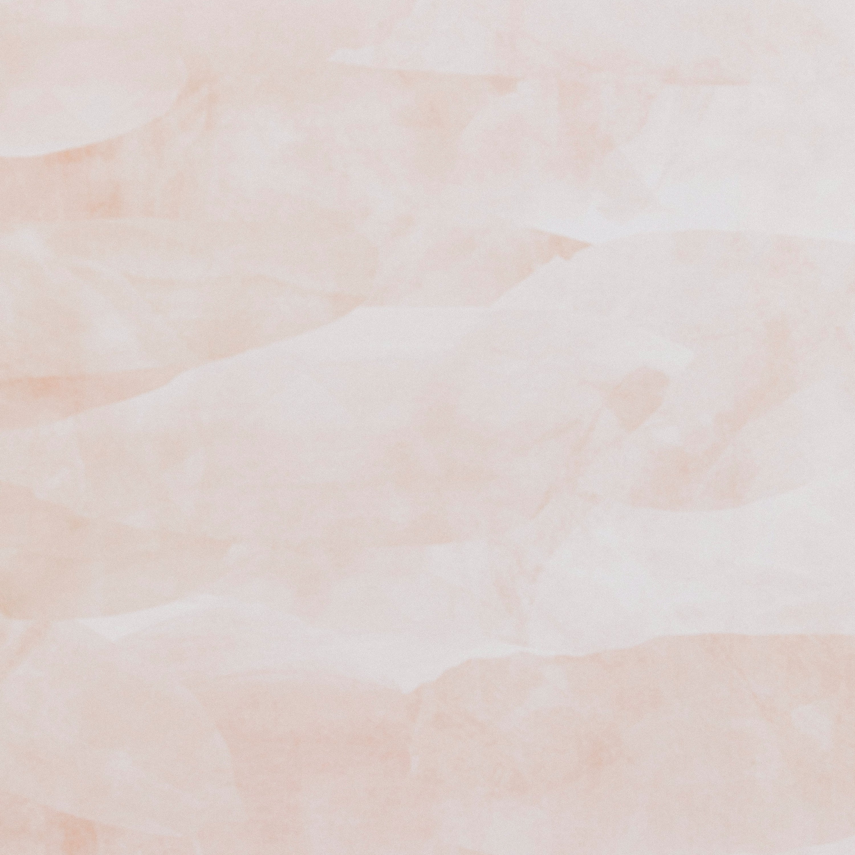 Detail of wallpaper in an abstract textural pattern in shades of white and pink.