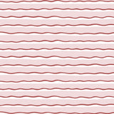 Detail of fabric in an undulating stripe pattern in red and white on a pink field.