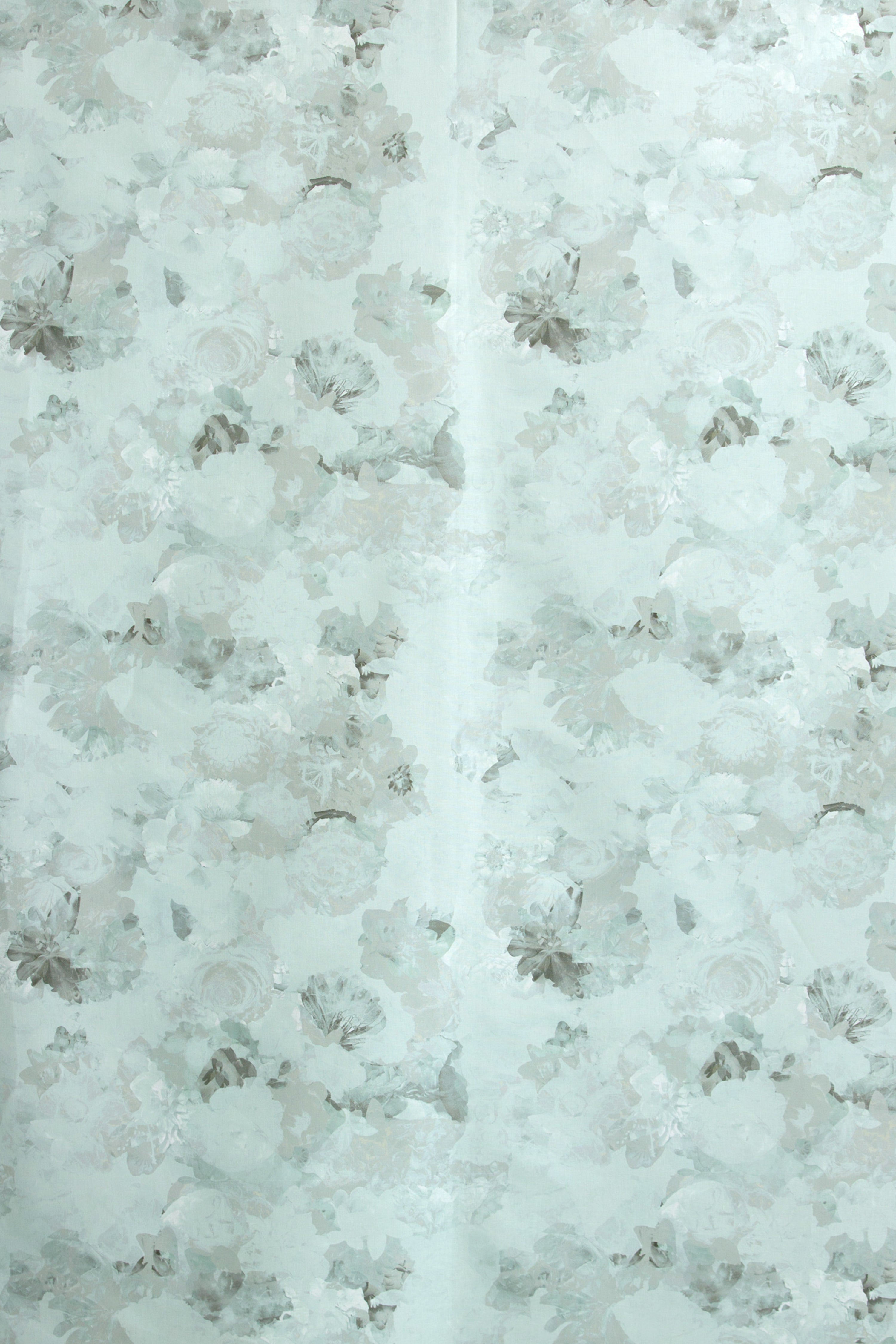 Detail of fabric in a dense photorealistic floral print in shades of gray and pastel green.