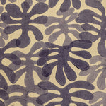 Detail of fabric in a playful repeating leaf print in shades of purple on a light yellow field.