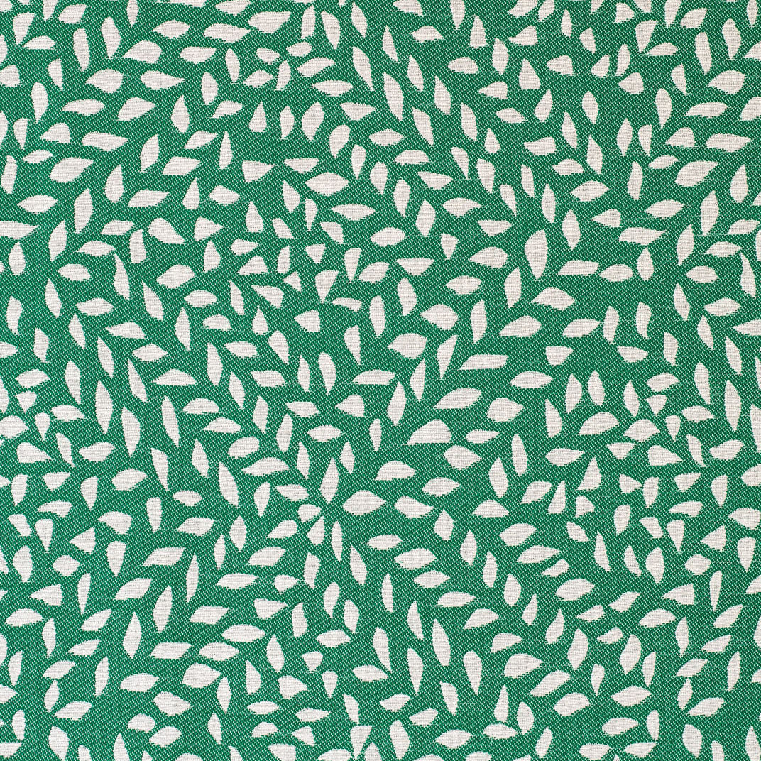 Detail of fabric in a botanical trellis print in white on a green field.