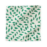 Square fabric swatch in a botanical trellis print in green on a white field.