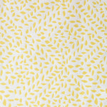 Detail of fabric in a botanical trellis print in yellow on a white field.