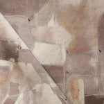 Draped fabric yardage in a textural paint blotch print in shades of brown and tan on a white field.