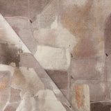 Draped fabric yardage in a textural paint blotch print in shades of brown and tan on a white field.