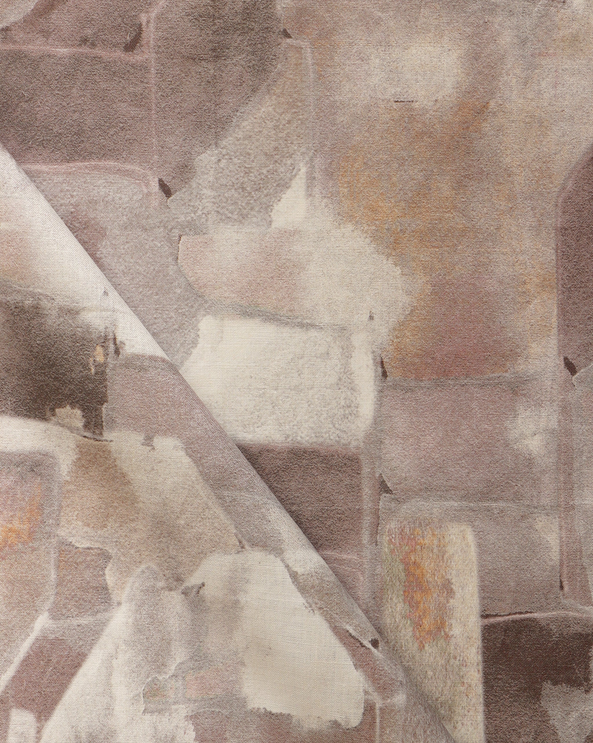 Draped fabric yardage in a textural paint blotch print in shades of brown and tan on a white field.