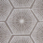 Fabric in a geometric lattice print in white on a light brown field.