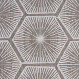 Fabric in a geometric lattice print in white on a light brown field.