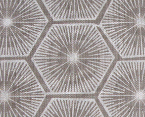 Fabric in a geometric lattice print in white on a light brown field.