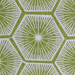 Fabric in a geometric lattice print in white on a green field.