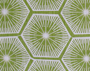 Fabric in a geometric lattice print in white on a green field.