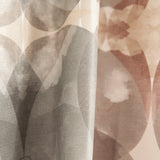 Close-up of draped fabric in a cloudy ink blot print in shades of gray and pink on a cream field.