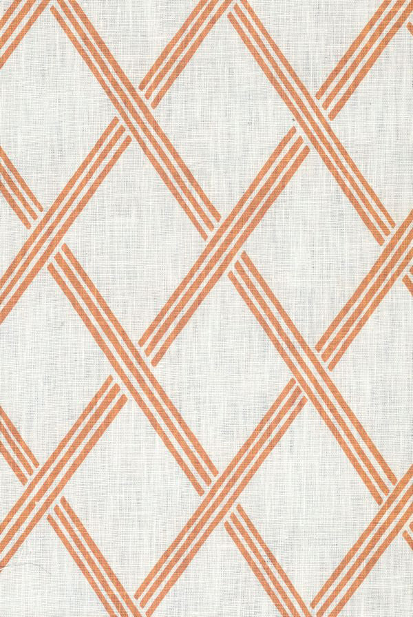 Detail of fabric in a diamond lattice print in orange on a white field.