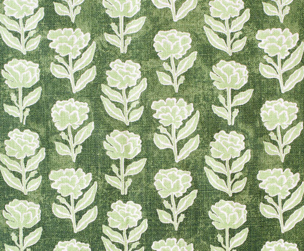 Detail of fabric in a floral grid print in light green and white on a dark green field.