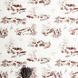 A vase of flowers stands in front of a wall covered in a playful illustrated car crash print in brown on a white field.