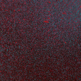 Close up of paint splatters in red, blue and black.