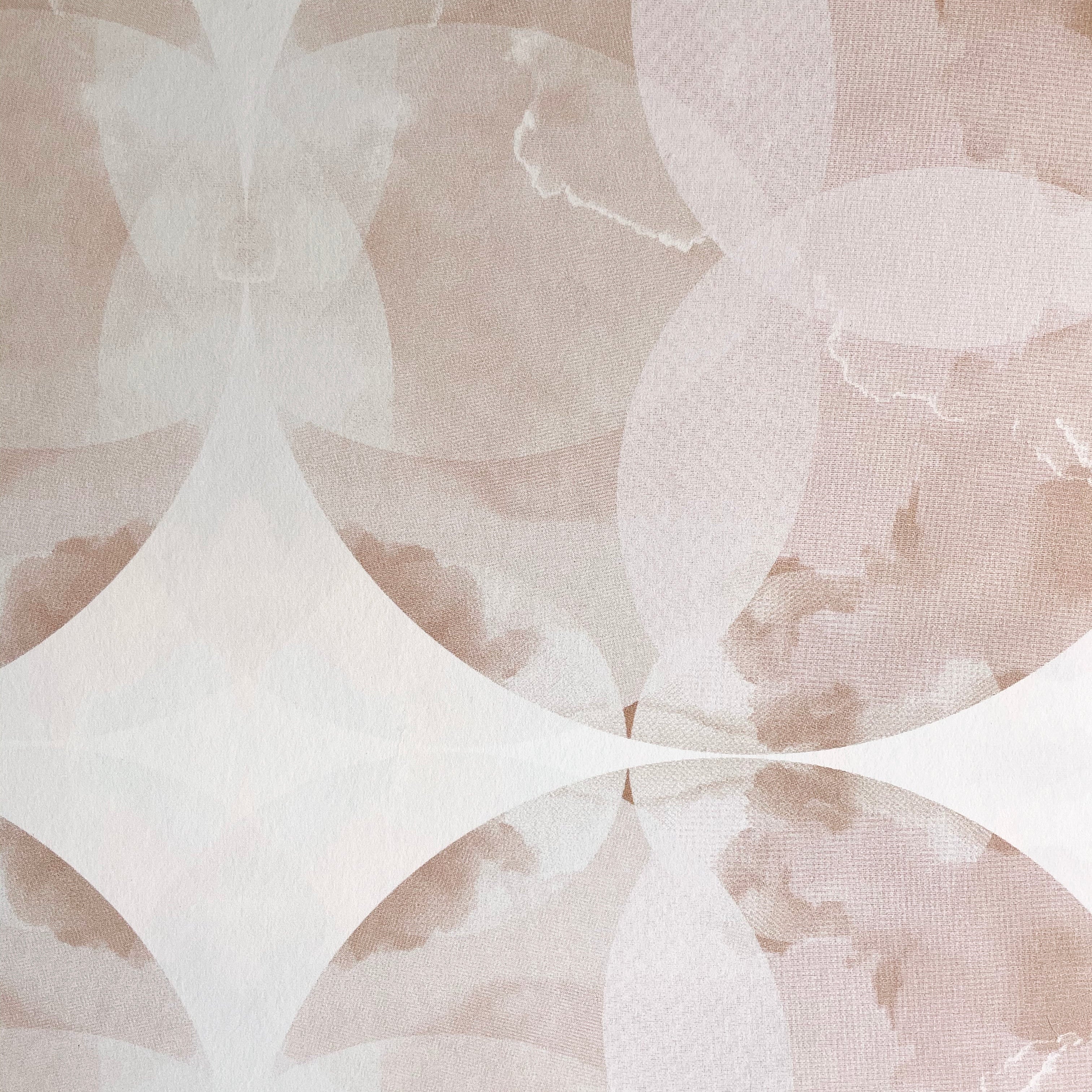 Close-up of wallpaper in a cloudy ink blot print in shades of brown and pink on a cream field.