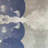 Close-up of wallpaper in a cloudy ink blot print in shades of blue and gray on a cream field.