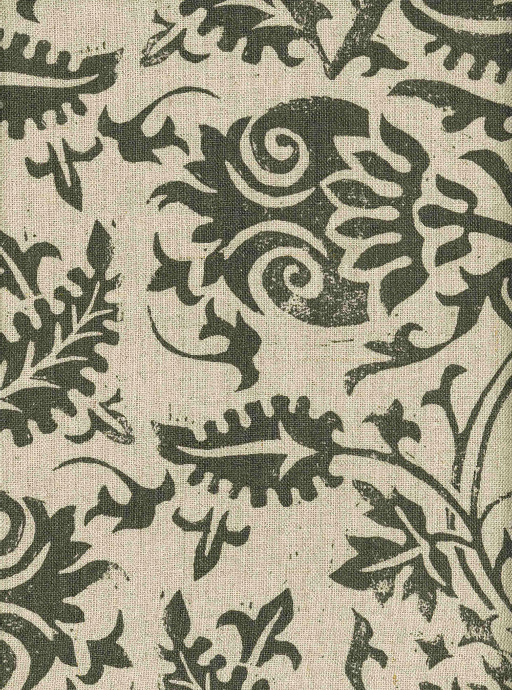 Detail of fabric in a floral damask print in green on a tan field.