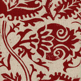 Detail of fabric in a floral damask print in red on a tan field.