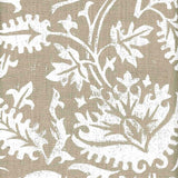 Detail of fabric in a floral damask print in white on a light brown field.