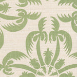 Detail of fabric in a playful botanical print in green on a cream field.