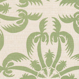 Detail of fabric in a playful botanical print in green on a cream field.