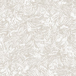 Detail of wallpaper in a painterly wave print in white on a cream field.