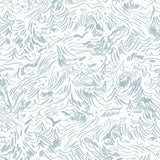 Detail of wallpaper in a painterly wave print in light blue on a white field.