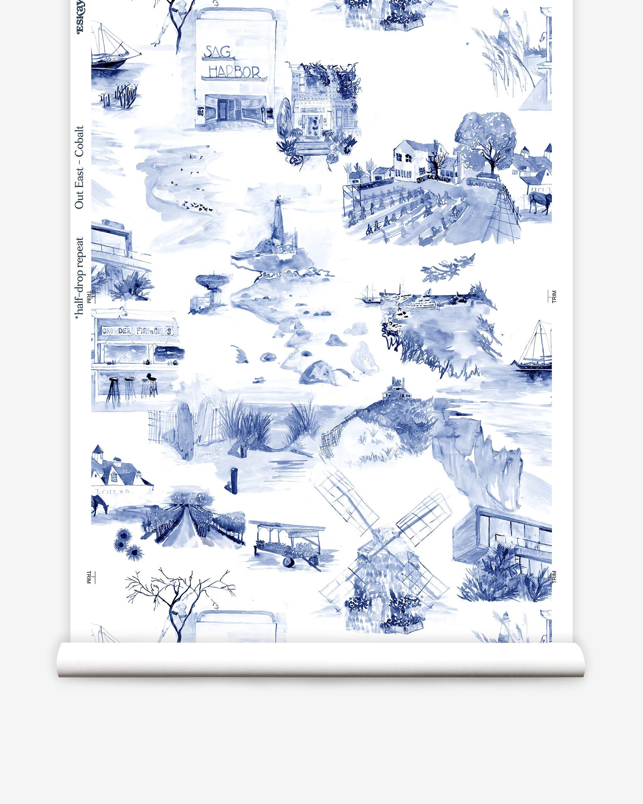Partially unrolled wallpaper yardage in a playful illustrated city print in navy, blue and white.