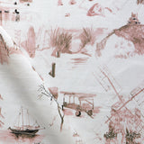 Draped fabric yardage in a playful painterly landscape print in pink and tan on a cream field.