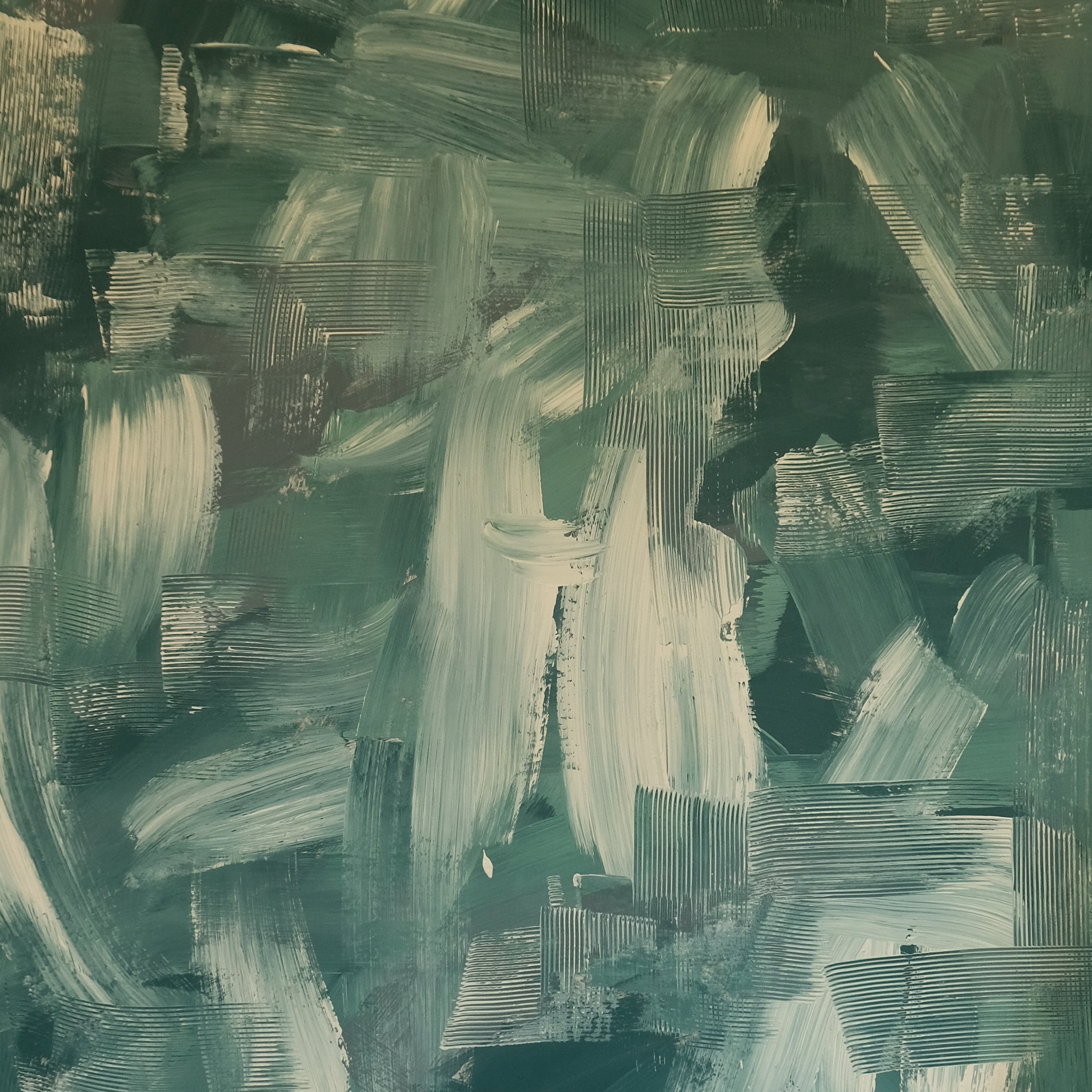 Detail of wallpaper in an abstract paint print in shades of green, turquoise and cream.