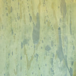 Detail of wallpaper in a textural paint splatter print in shades of green and blue.