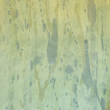 Detail of wallpaper in a textural paint splatter print in shades of green and blue.