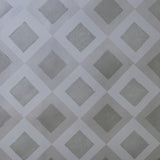 Detail of wallpaper in a diamond lattice print in shades of gray.