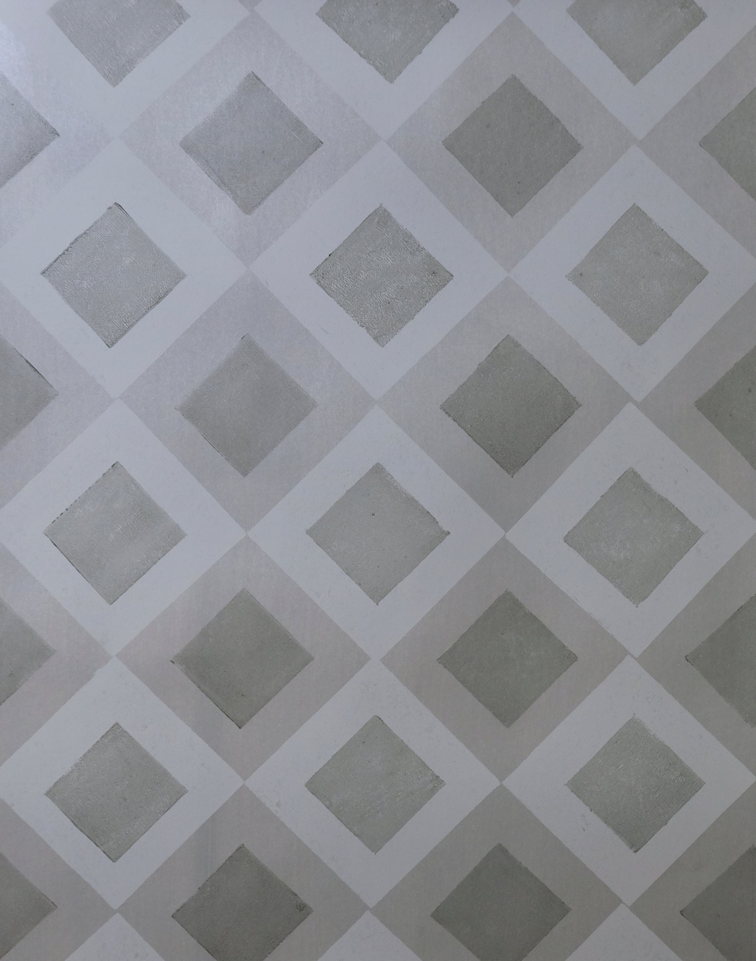 Detail of wallpaper in a diamond lattice print in shades of gray.