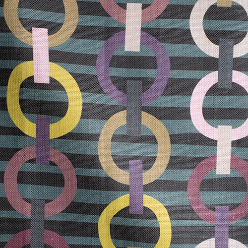 Draped fabric in a playful paper chain stripe print in shades of pink, purple, gold and green on a black field.